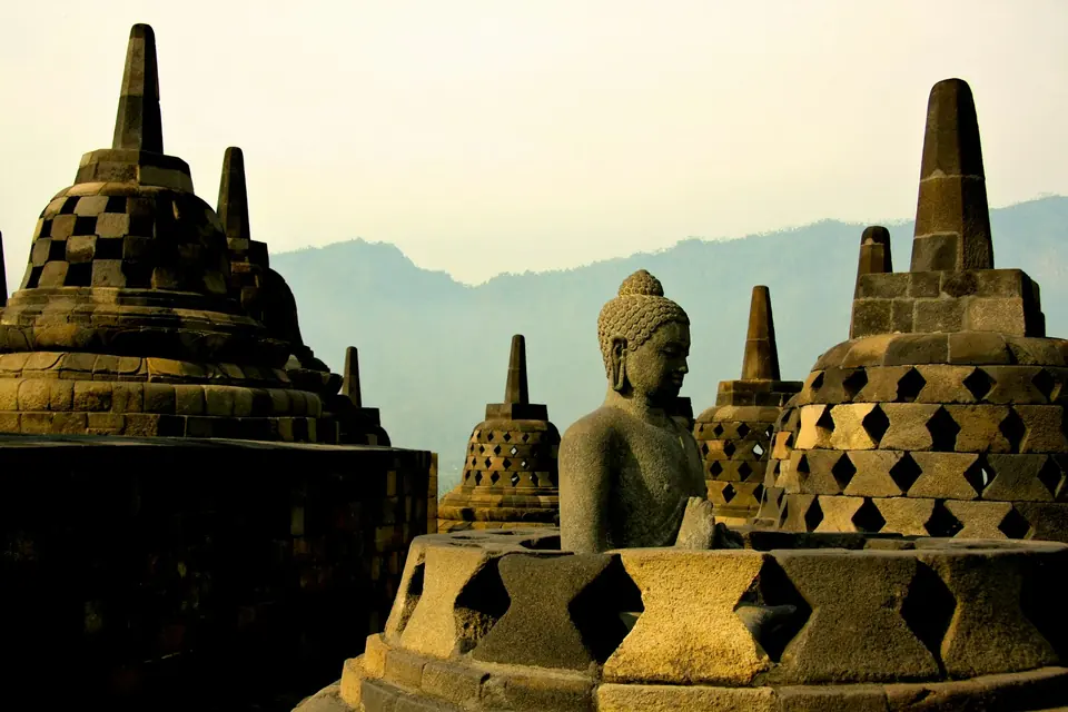 Buddha statue and stupas at Borobudur temple at sunrise, Central Java