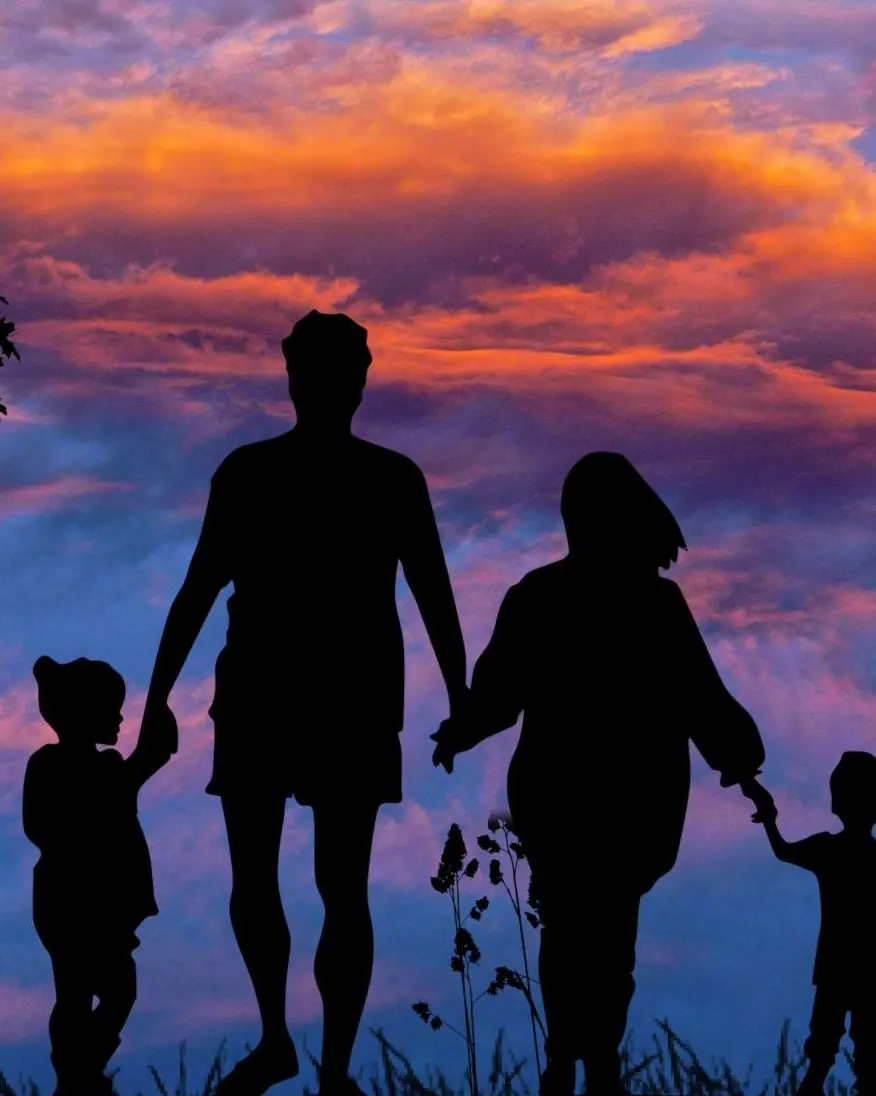 Family walking at sunset