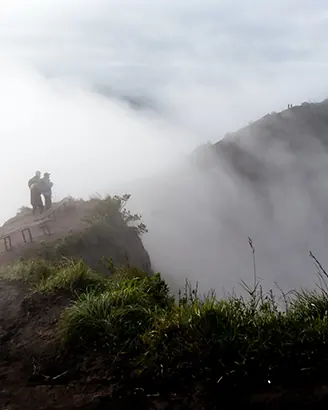 Hiker on a misty mountain ridge